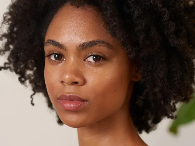 A close-up portrait of a model with clear, healthy skin, representative of the skin care category